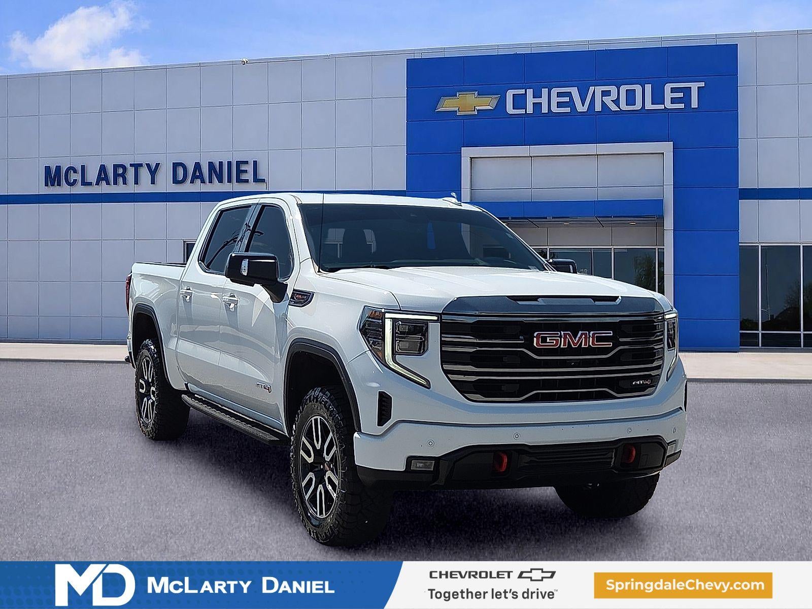 2023 GMC Sierra 1500 AT4 in Summit White — front three-quarter view
