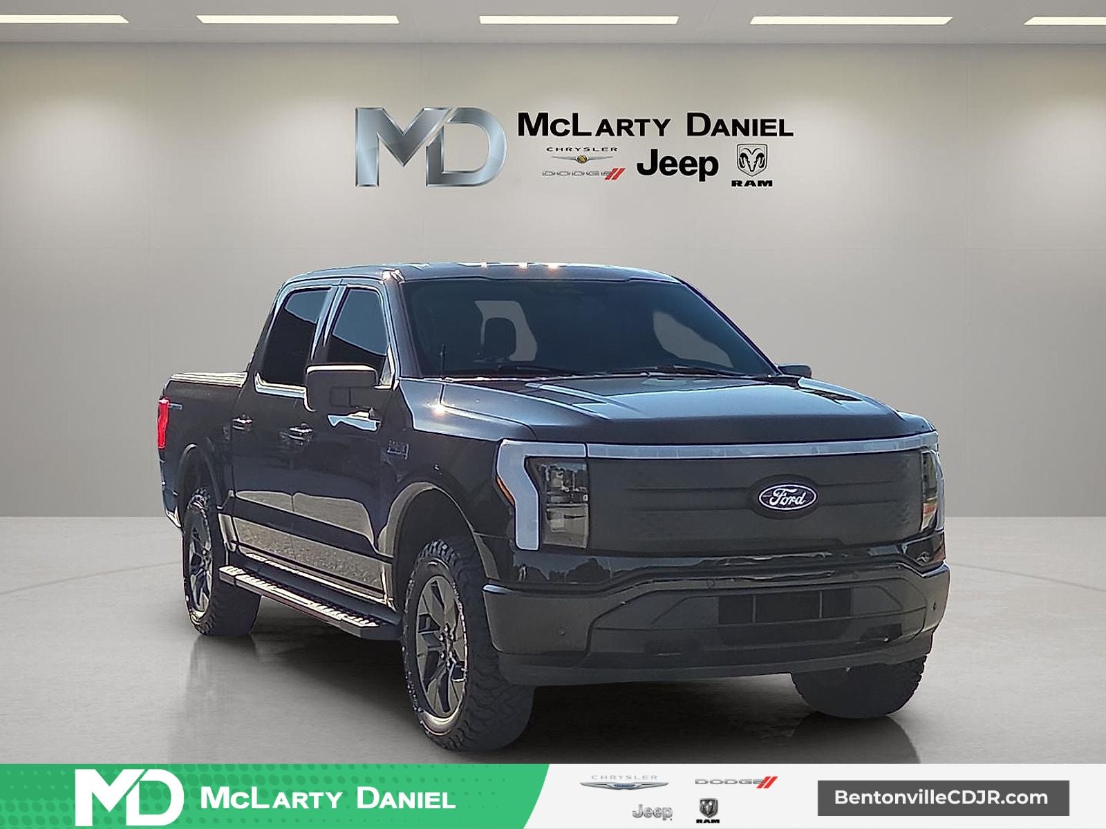 2024 Ford F-150 Lightning Flash in Black Metallic — front three-quarter view